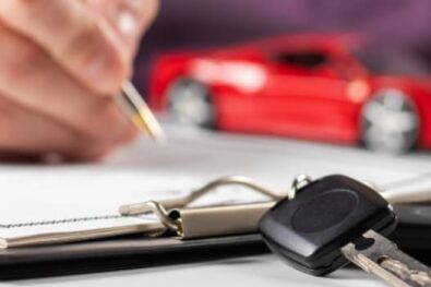 Man filling out documents for car