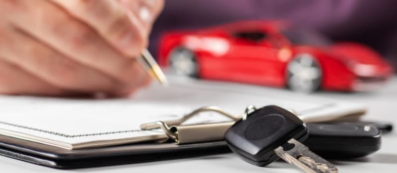 Man filling out documents for car