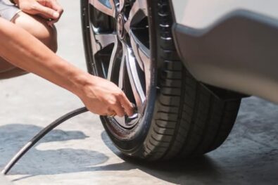 Man inflating car tire