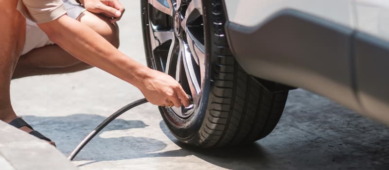 Man inflating car tire