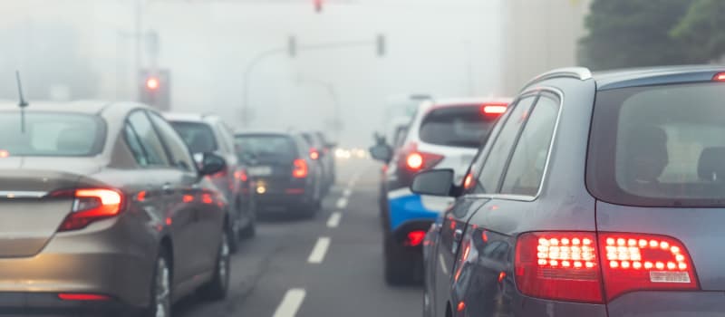 car on traffic lights on a cold and foggy day