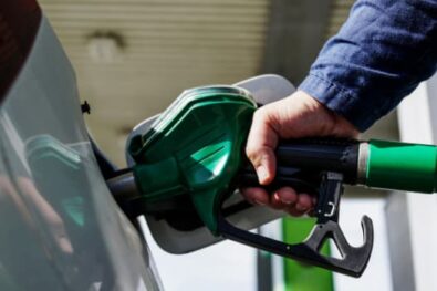 man filling car with fuel