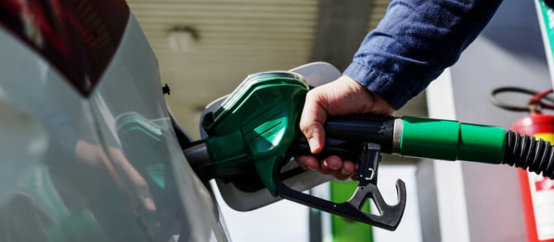 man filling car with fuel