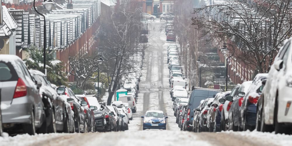 car driving uphill on snowy road