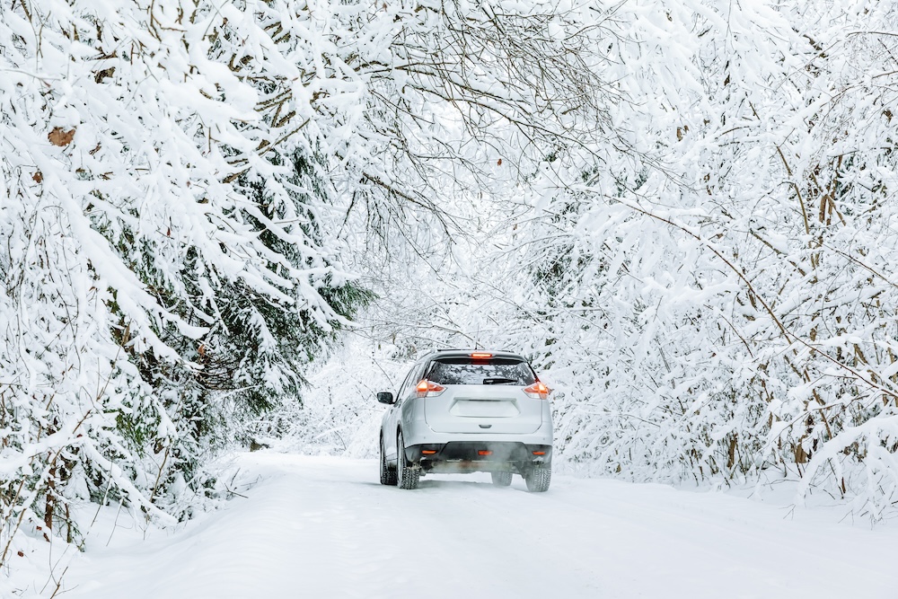 car on a winter road covered in snow